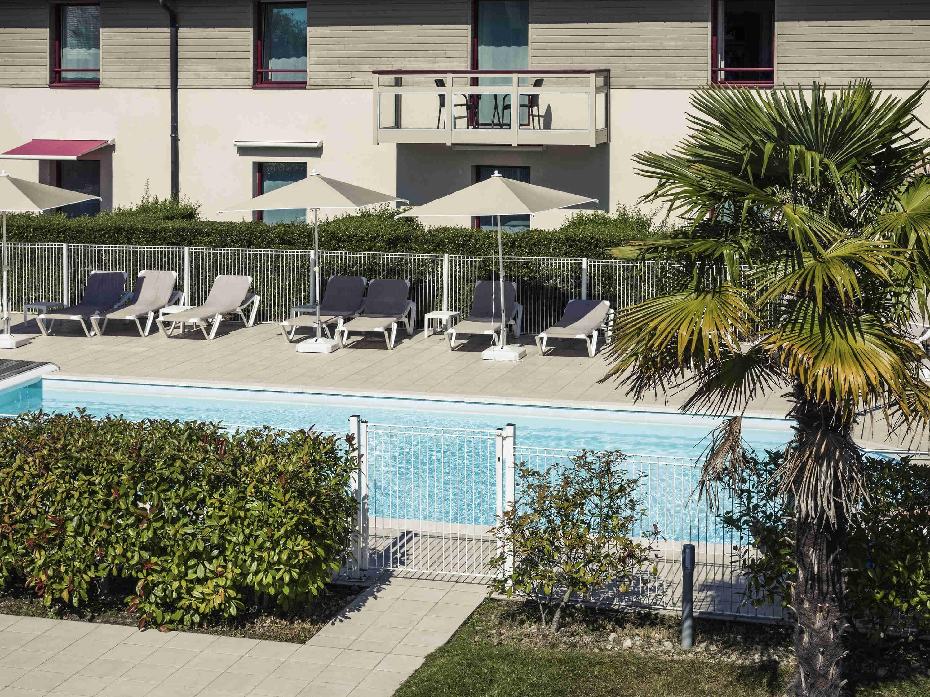 outdoor pool, pool umbrellas, pool loungers