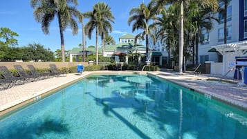 Outdoor pool, open 7 AM to 10 PM, pool umbrellas