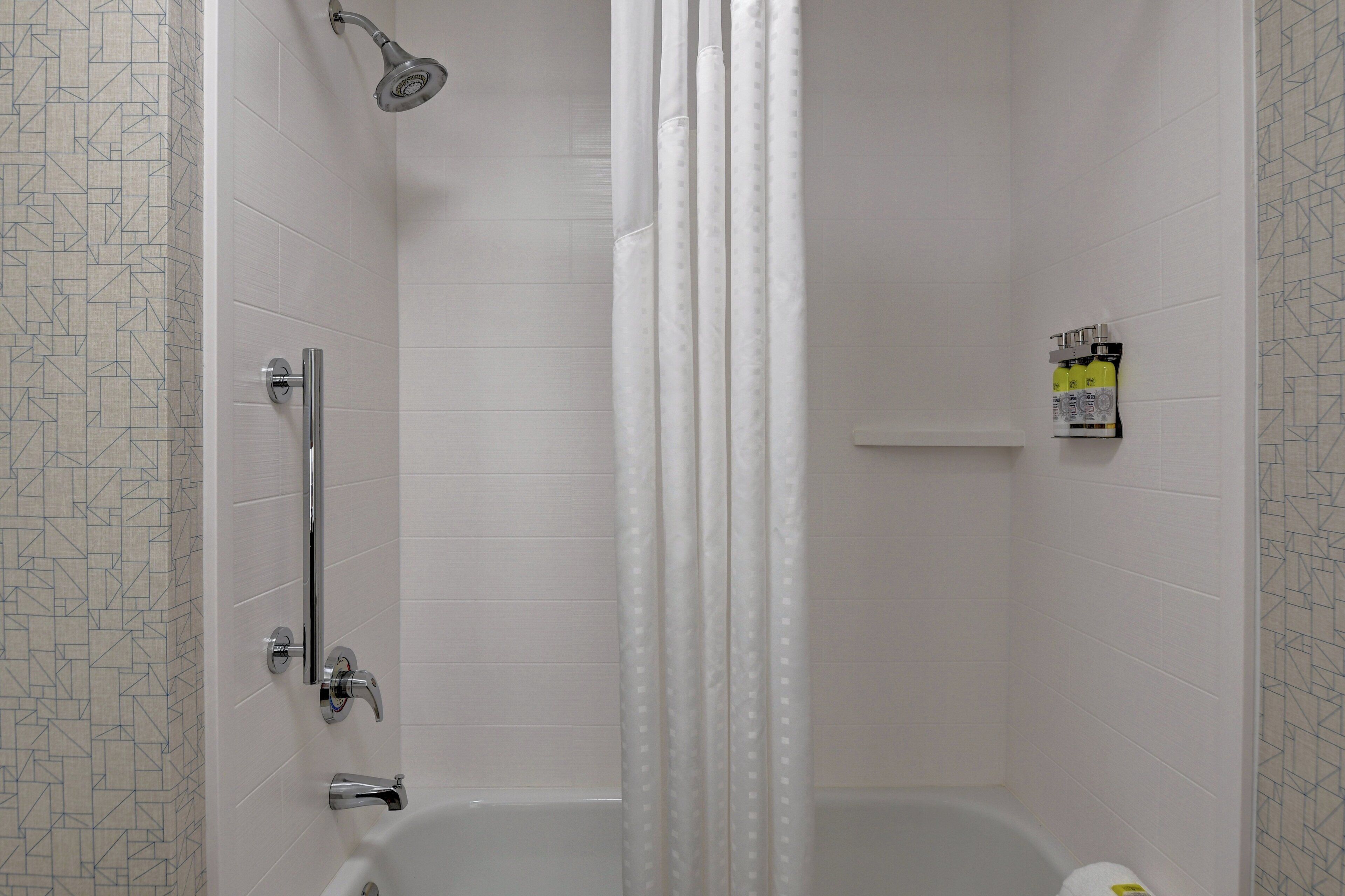A bathroom with a shower, a bathtub, and a toilet.