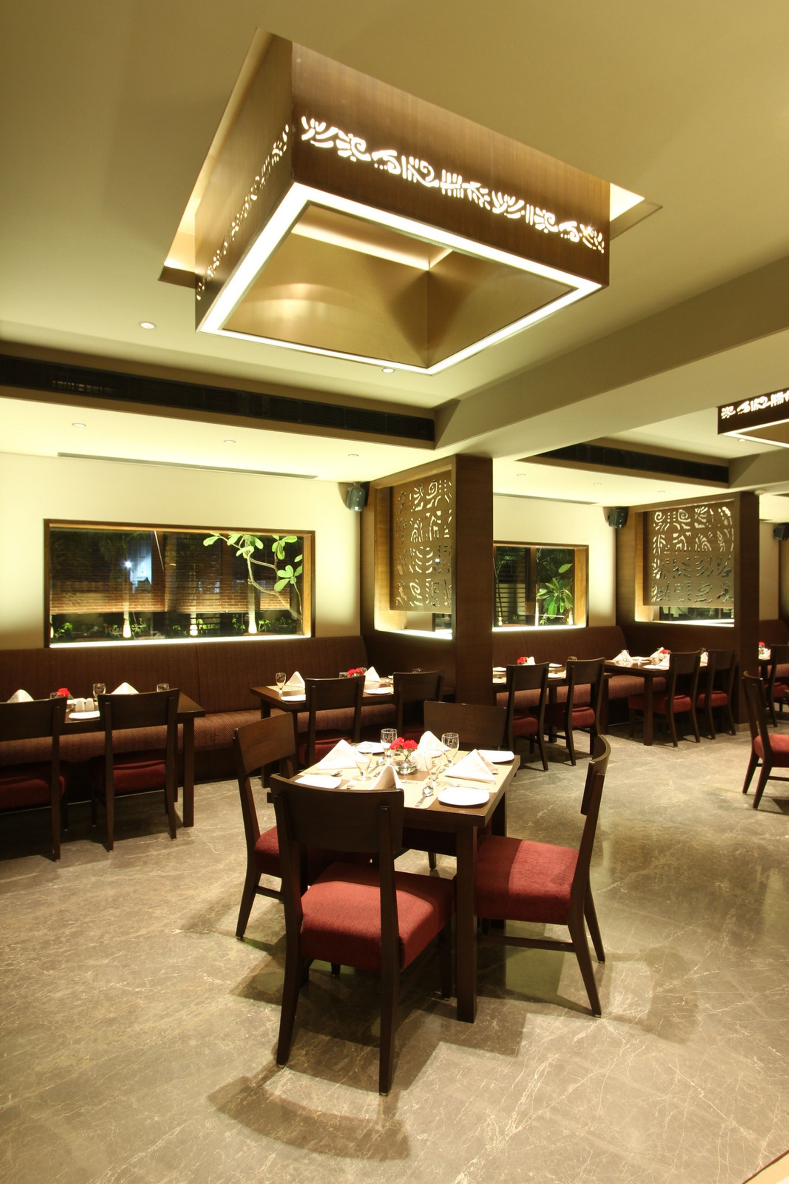 A restaurant with booths and tables, wooden decor, and large windows.