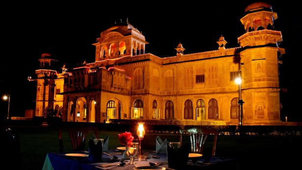 A grand building with multiple domes and arches, illuminated at night. - The Lallgarh Palace - A Heritage Hotel (Bikaner)