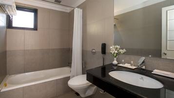 Un baño moderno con bañera, inodoro y lavamanos.