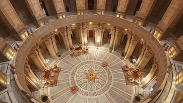Stunning atrium with ornate columns and patterned floor, perfect for relaxation or social gatherings.