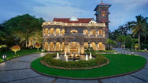 A historic building with a central courtyard, a fountain, and a tower. - The Leela Kovalam, a Raviz Hotel (Neyyattinkara)