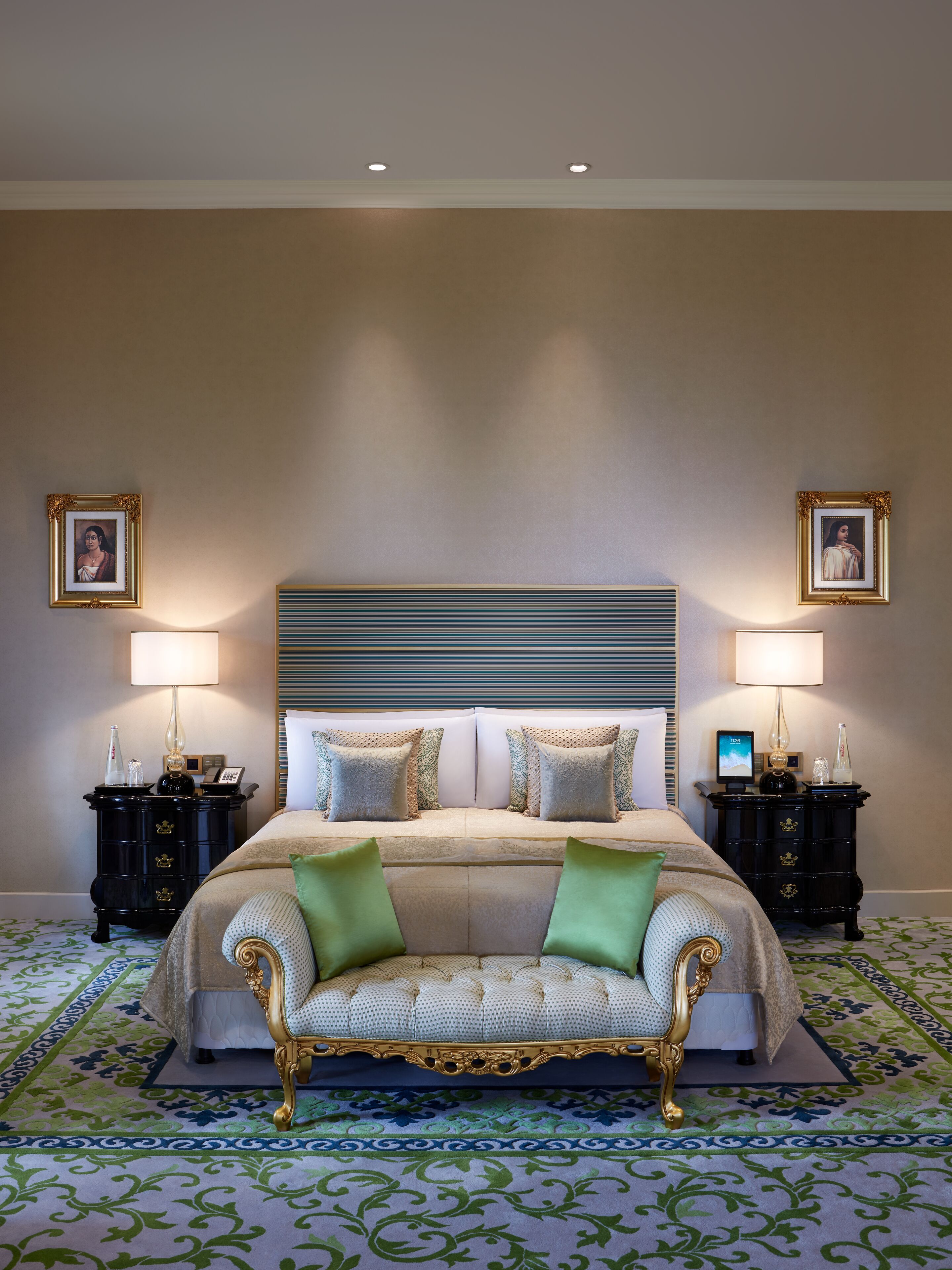 A spacious bedroom with a large bed, two nightstands, and a decorative headboard.