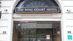The entrance to The Rose Court Hotel with a glass door and a sign above. - Rose Court Hotel (London)