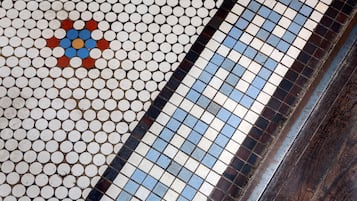 A close-up of a tiled floor with a pattern of white, blue, and red tiles.