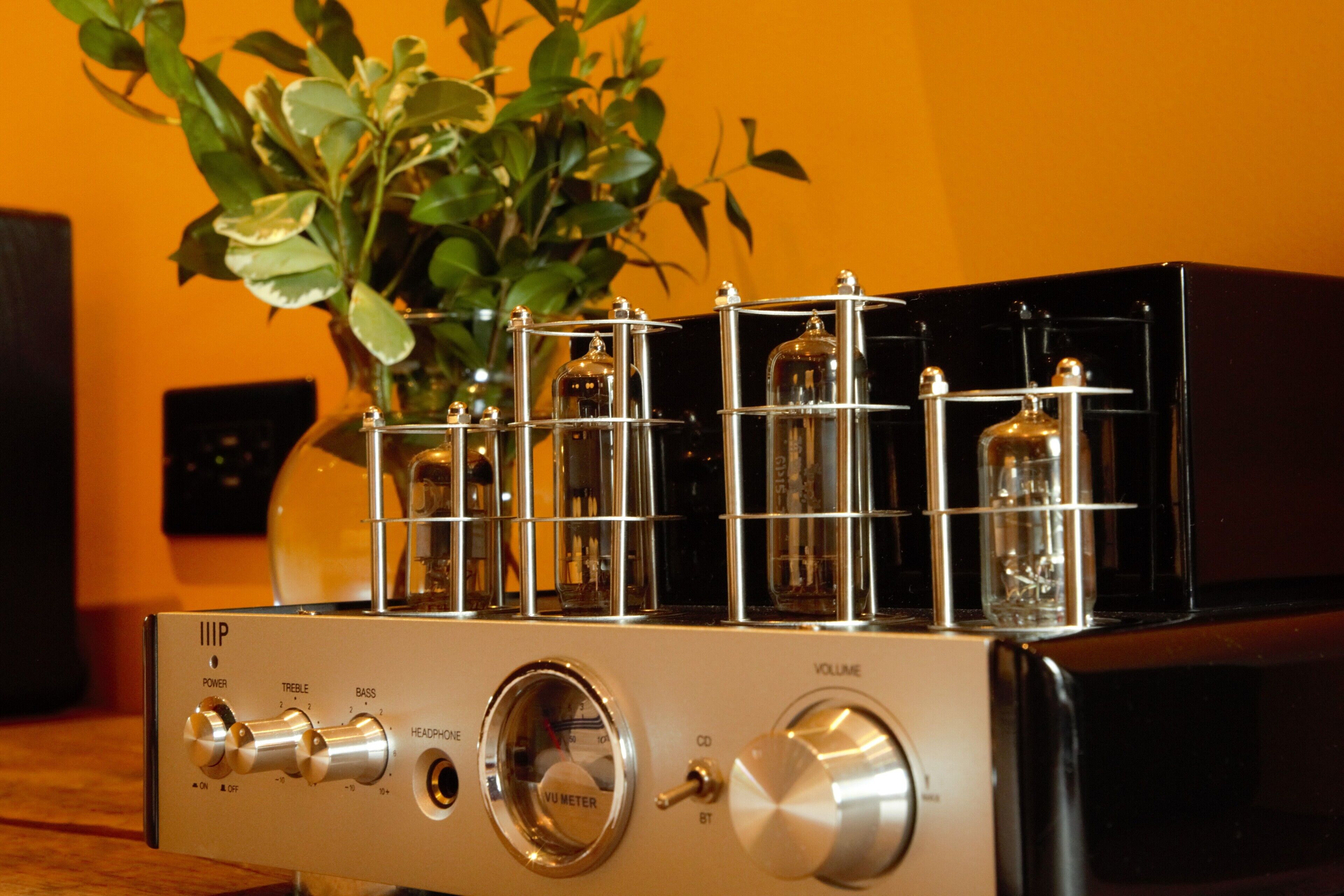 A vintage audio amplifier with multiple knobs and tubes.