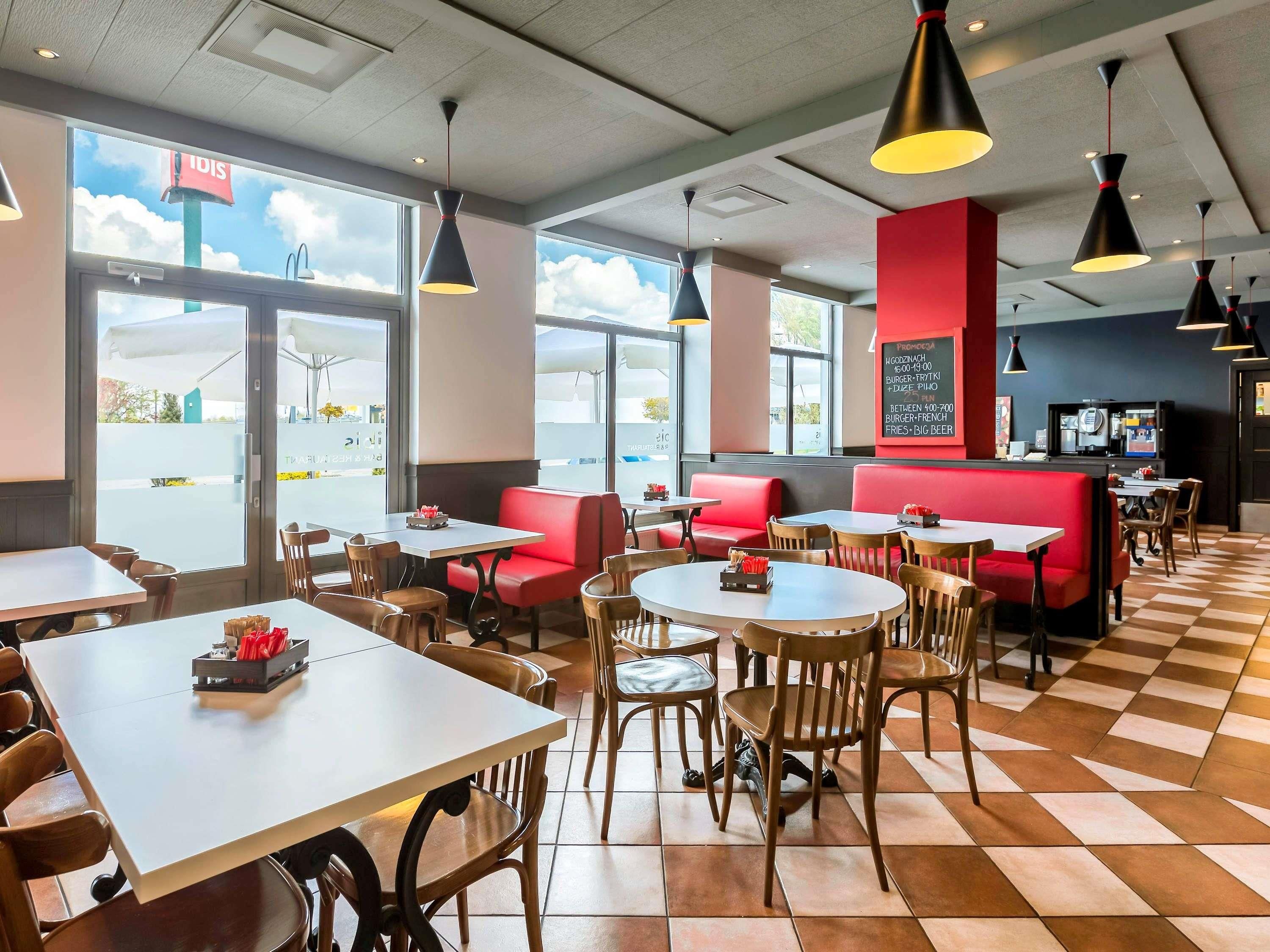 A restaurant interior with tables, chairs, and a counter.