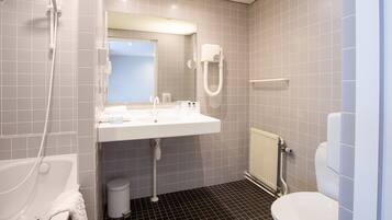 A bathroom with a bathtub, a sink, a toilet, and a shower.