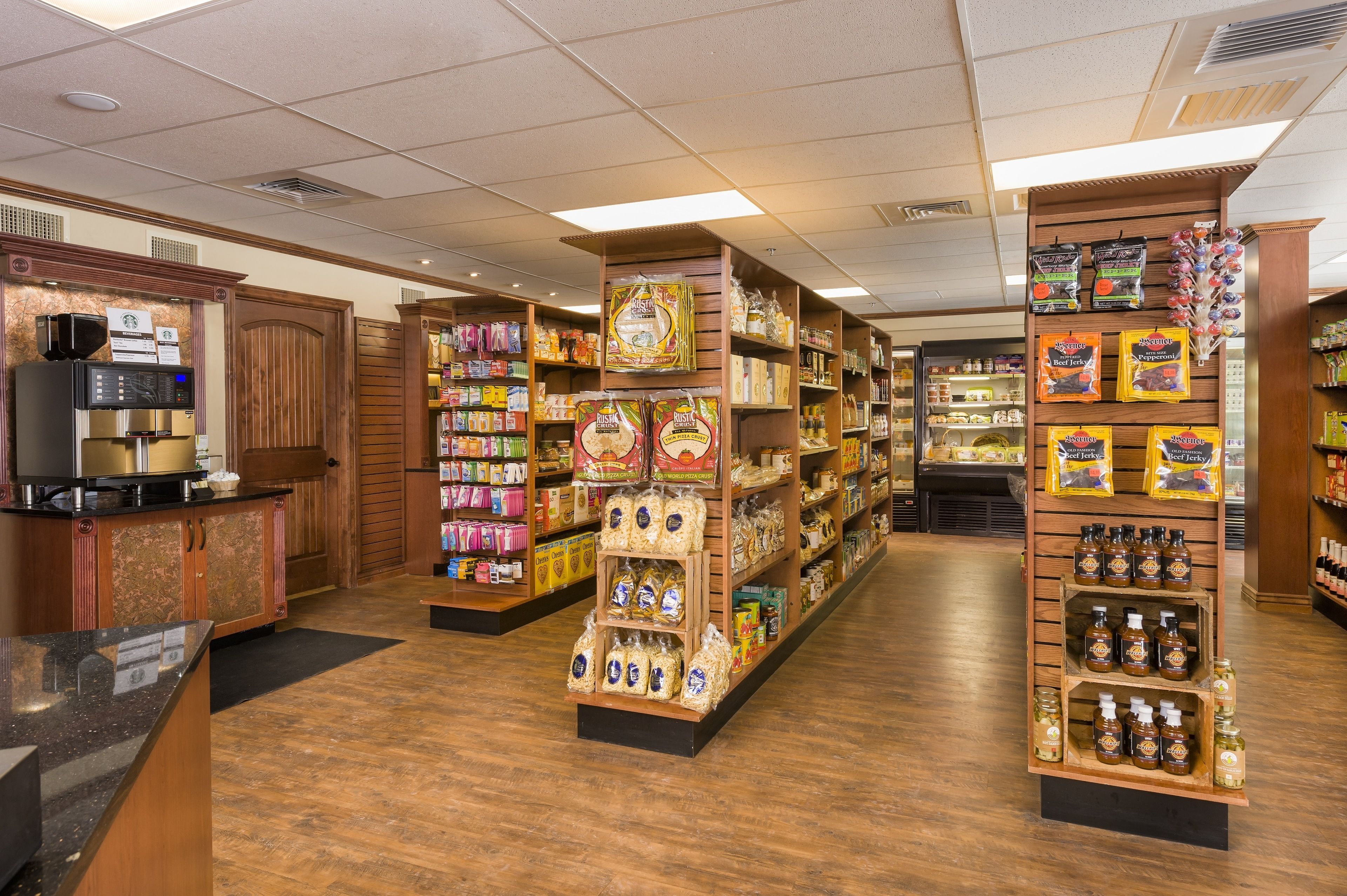 A bakery section with shelves stocked with bread, pastries, and condiments.