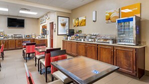 A breakfast area with wooden cabinets, a coffee station, and a refrigerator. - Comfort Inn Columbus near Fort Benning (Columbus)