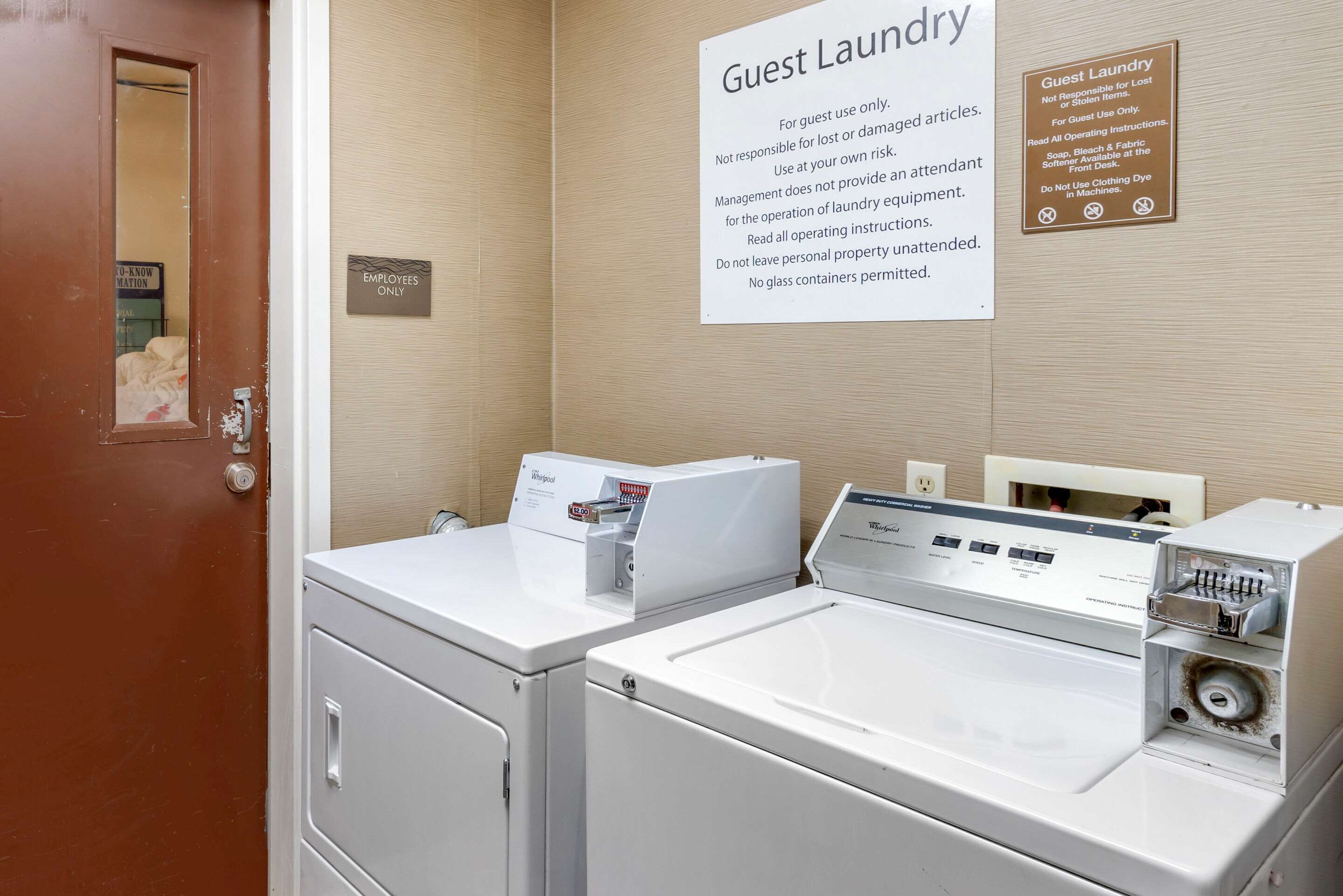 A guest laundry area with two washing machines and a sign indicating it is for guest use only.