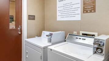 A guest laundry area with two washing machines and a sign indicating it is for guest use only.