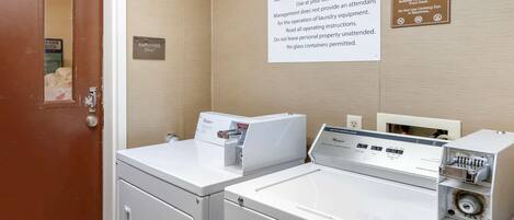 A guest laundry area with two washing machines and a sign indicating it is for guest use only.