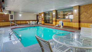 An indoor swimming pool with a glass table and chairs, surrounded by wooden walls and a tiled floor. - Comfort Inn Columbus near Fort Benning (Columbus)