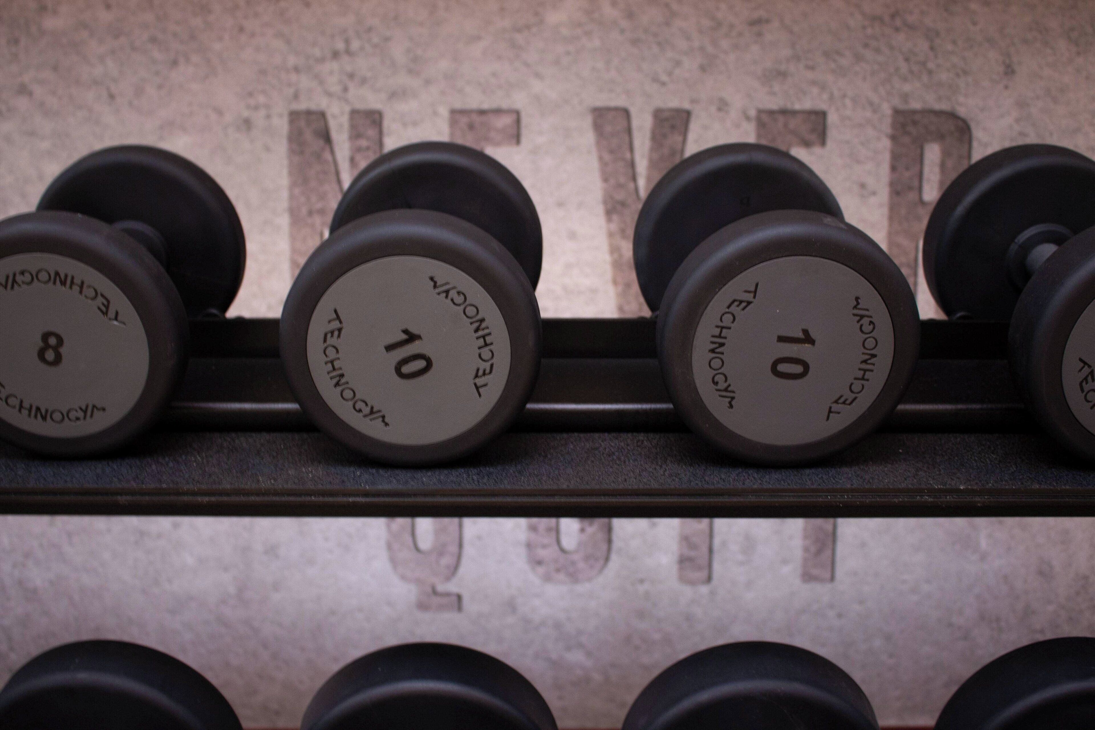 A rack of dumbbells with weight labels.