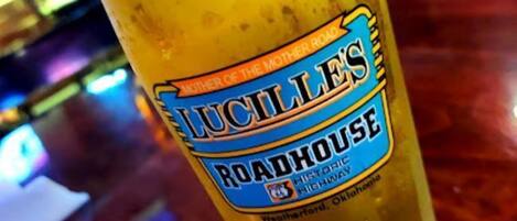 A glass of beer with a label reading "Lucille's Roadhouse Historic Highway" in Weatherford, Oklahoma.