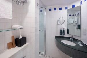 Shower, designer toiletries, hair dryer, towels