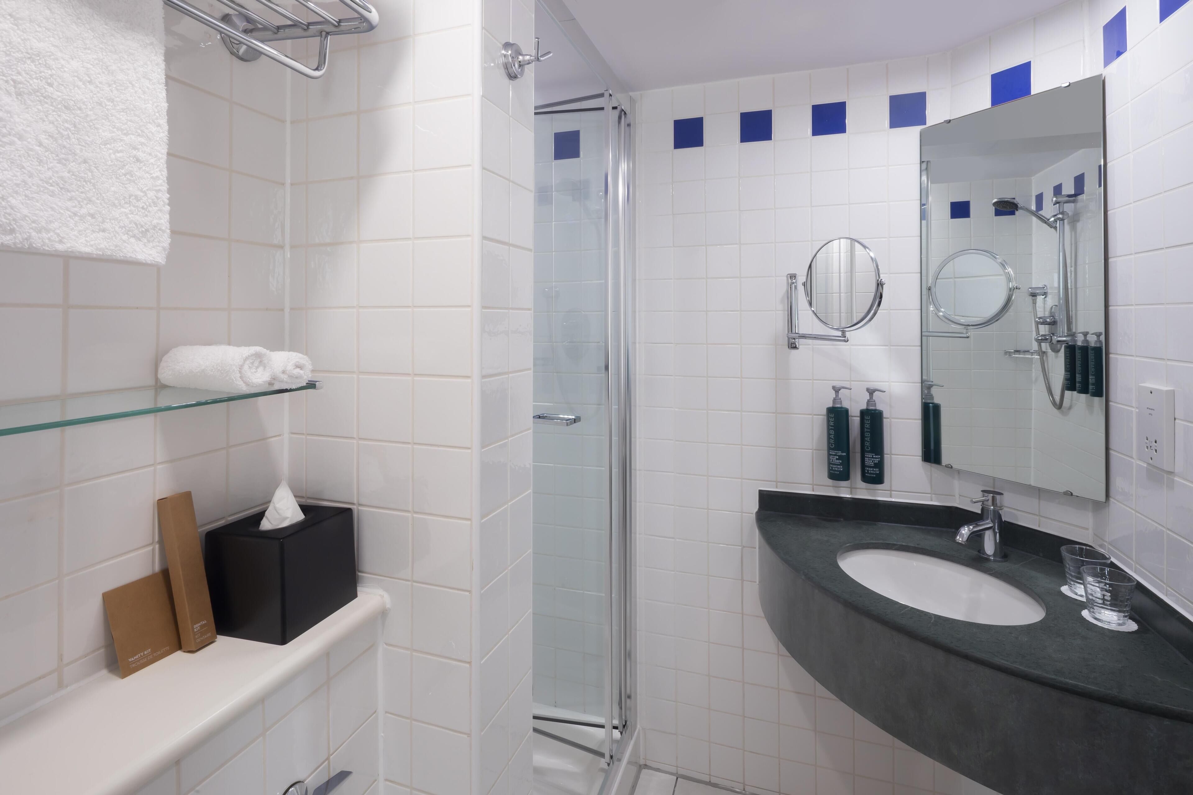 Shower, designer toiletries, hair dryer, towels