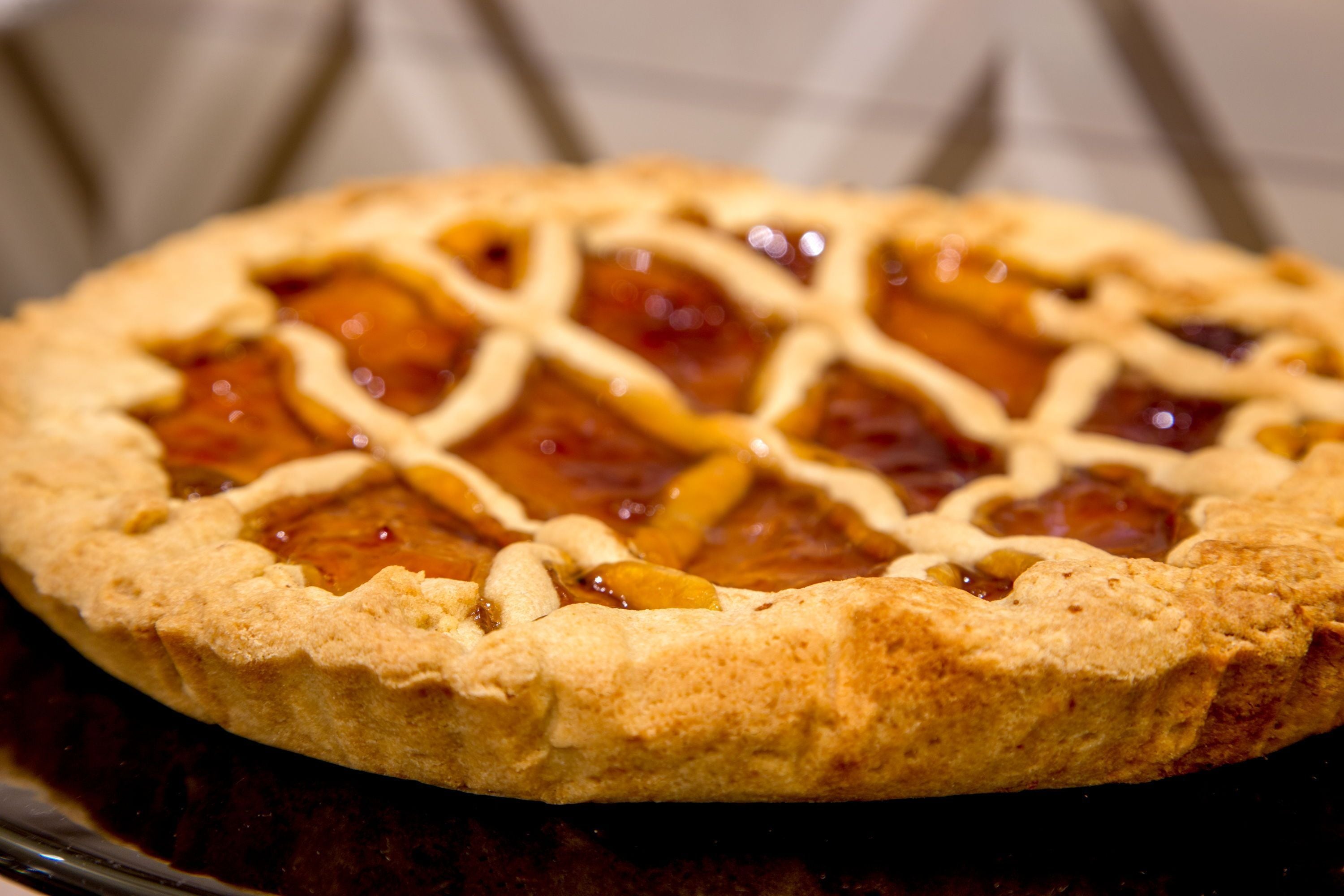 A pie with a lattice crust on a plate.