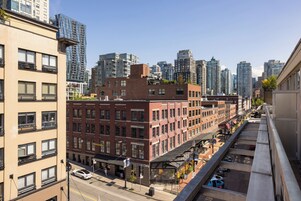 A multi-story building with a mix of commercial and residential spaces, including a cafe and parking garage.