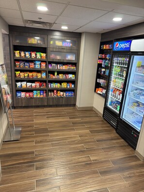 A snack and beverage vending area with a Pepsi refrigerator. - Residence Inn By Marriott Flint (Flint)
