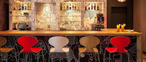 A bar area with a counter, bar stools, and a wall with line drawings.