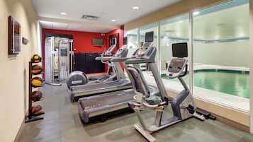 A gym with treadmills, elliptical machines, and a rowing machine.