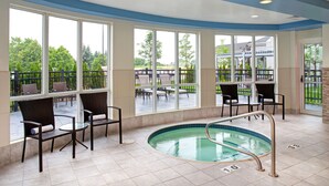 A pool area with chairs and a pool. - Hilton Garden Inn Toronto/Oakville (Oakville)