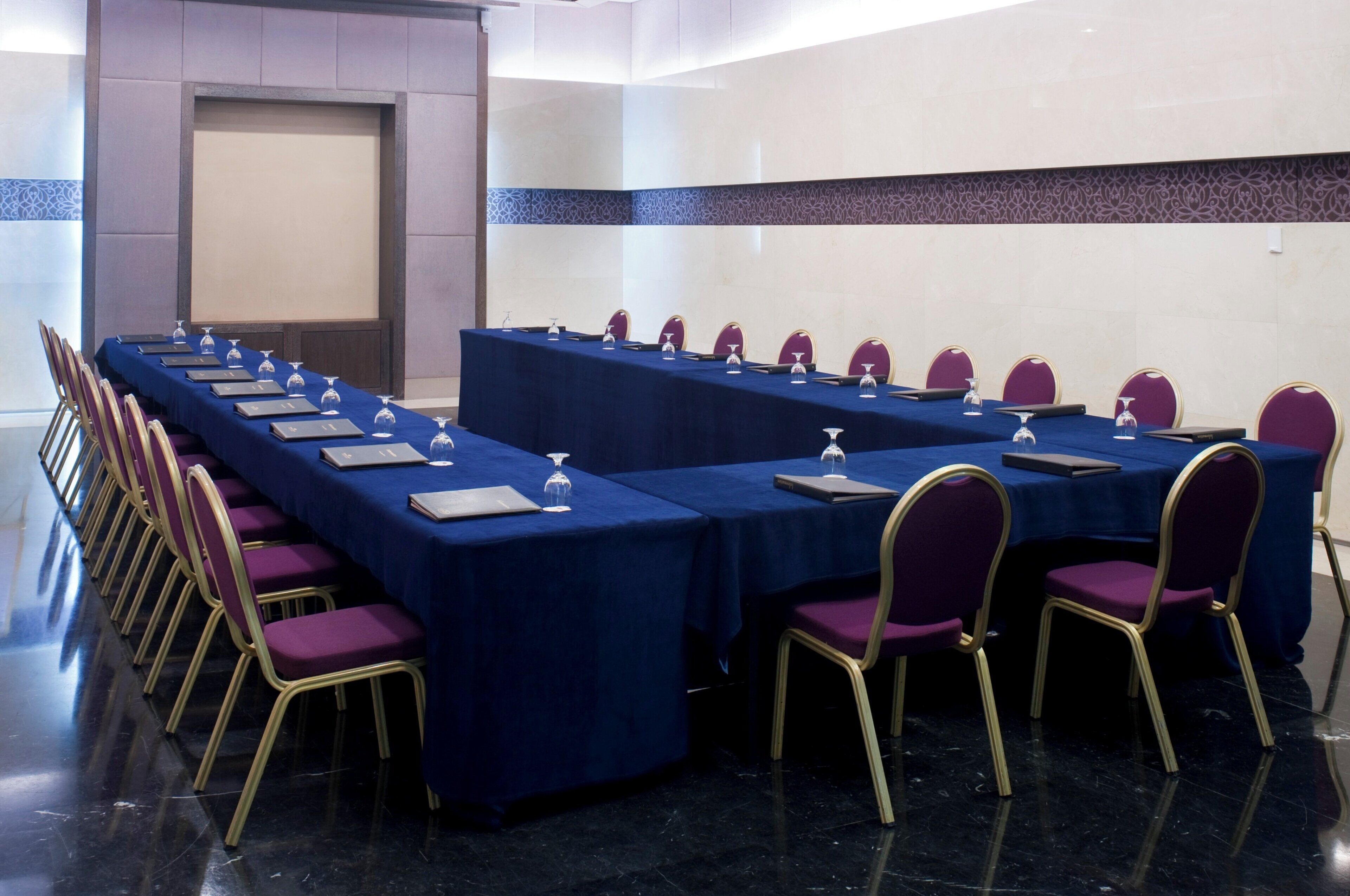 A conference room with a long table, chairs, and nameplates.
