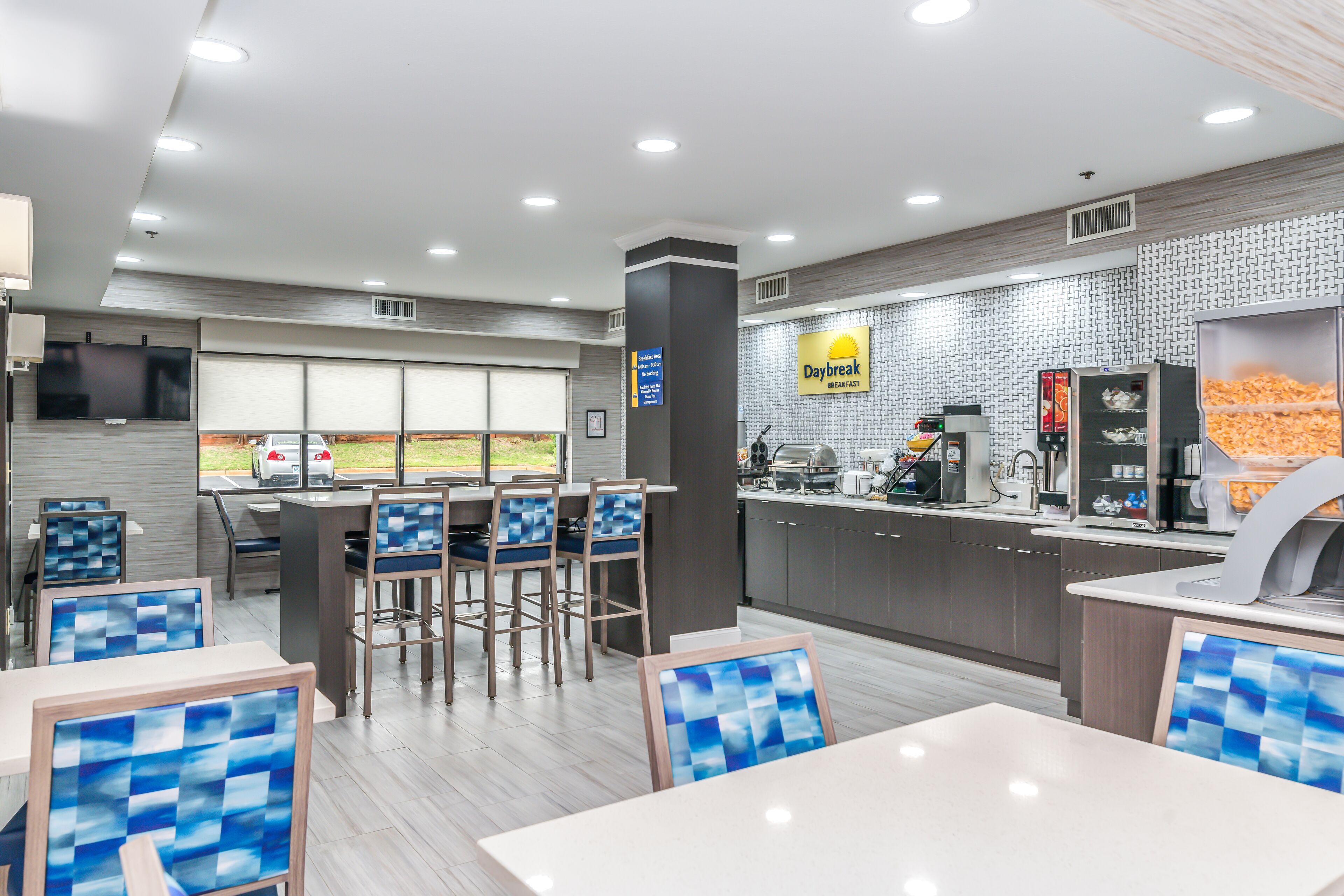 A modern breakfast area with seating and a counter.