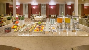 A buffet setup with various food items and beverages.