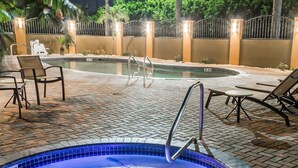 A hot tub with a 3 FT depth marker, surrounded by lounge chairs and a tiled patio area. - Comfort Inn & Suites Pharr - McAllen (Pharr)