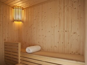 A wooden sauna with a bench and a towel. - The Classic Hotel Nicosia - Handwritten Collection (Nicosia)