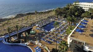 Ein Resort mit Poolbereich, Strand und Meerblick.