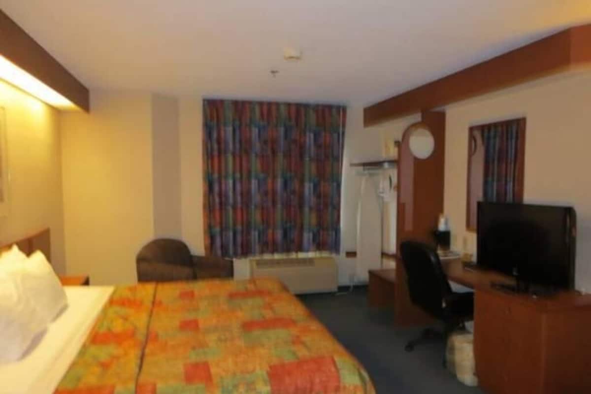 Desk, laptop workspace, blackout drapes, iron/ironing board