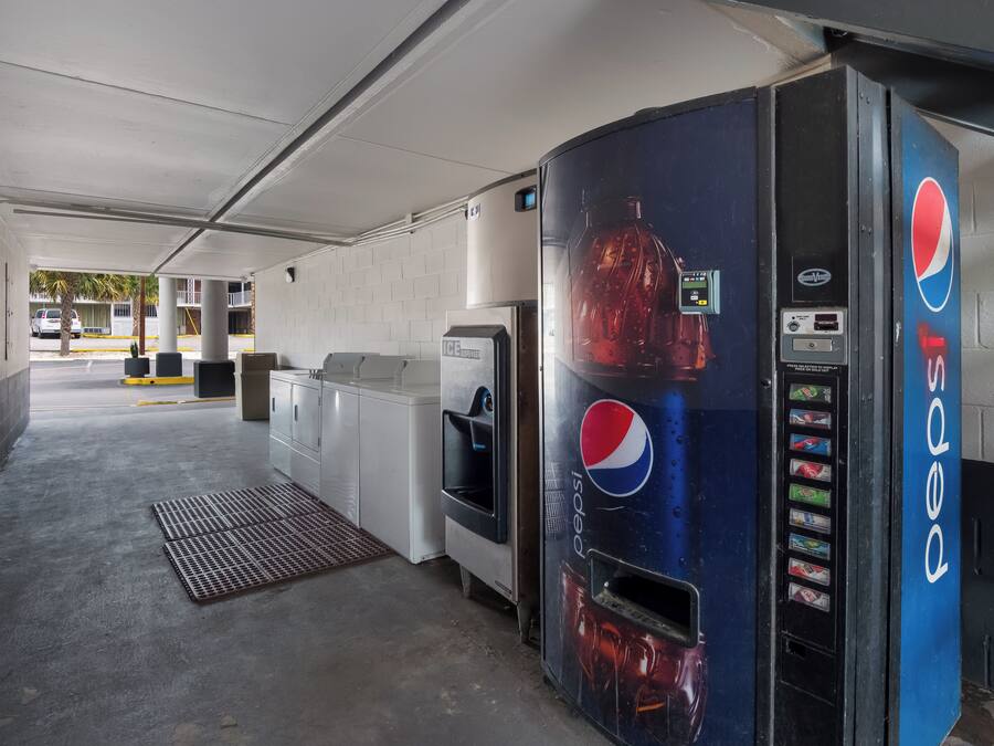 A parking garage with a Pepsi vending machine, a water dispenser, and a SureVend machine.