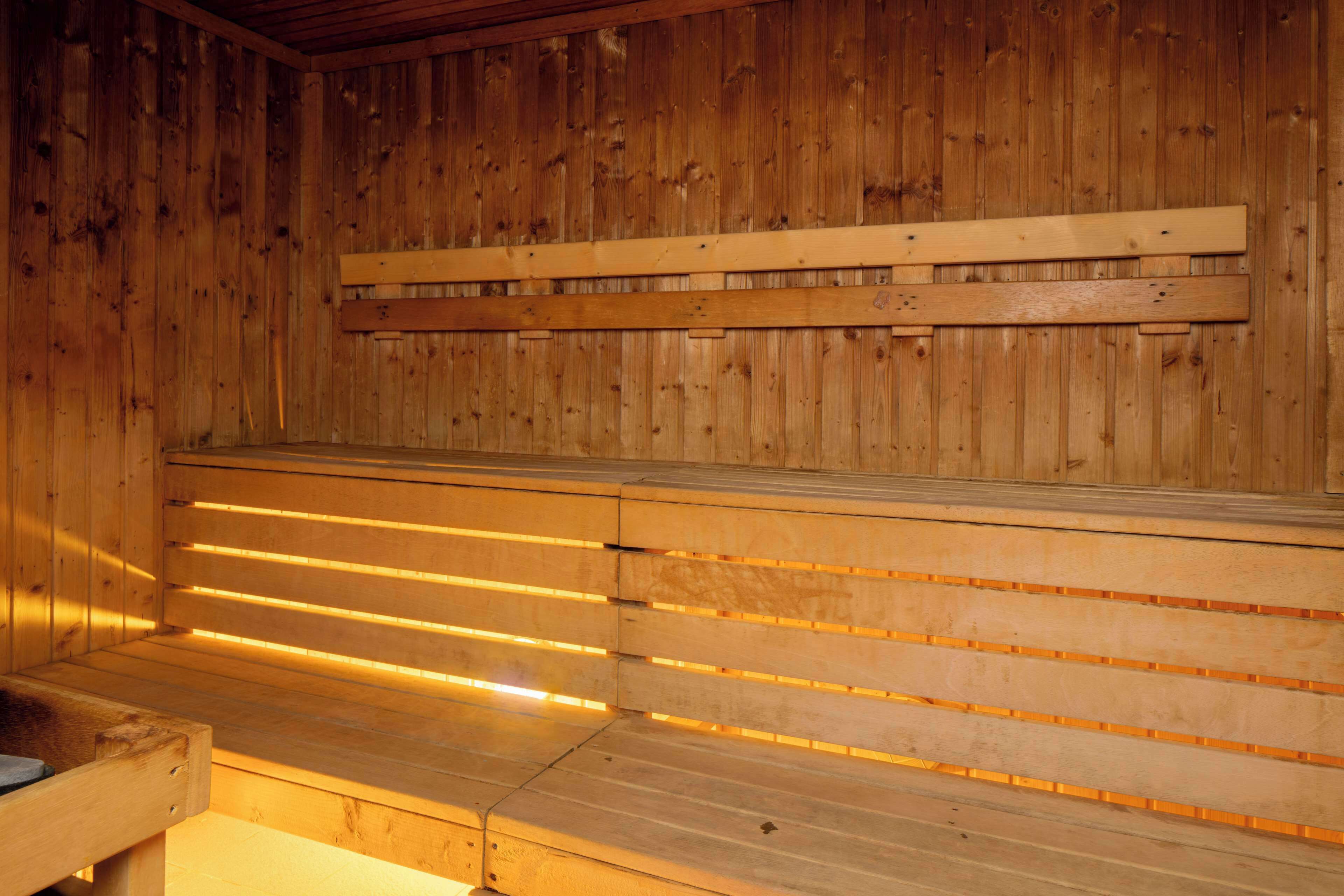 A sauna with wooden benches and slatted walls.