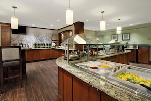 A buffet area with a variety of food options, including fruits and a salad bar, in a hotel setting. - Staybridge Suites Tysons - McLean by IHG (McLean)