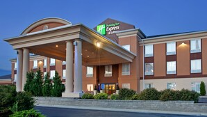 A Holiday Inn Express & Suites building with a covered entrance, multiple windows, and a landscaped front area. - Holiday Inn Express & Suites Lawrence by IHG (Lawrence)