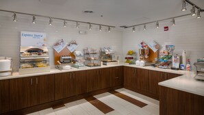 A modern kitchen area with a bread display, a coffee station, and a sign for 'Express Start'.