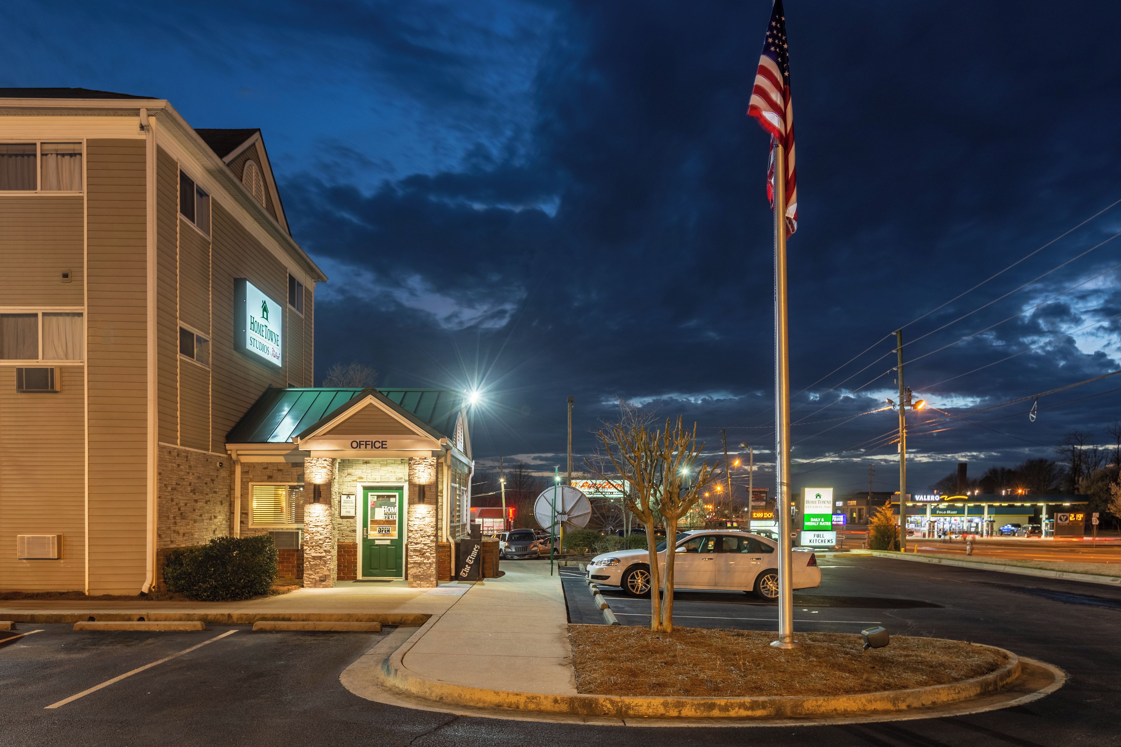 A building with a sign reading 'Home Town Studios' and an American flag.