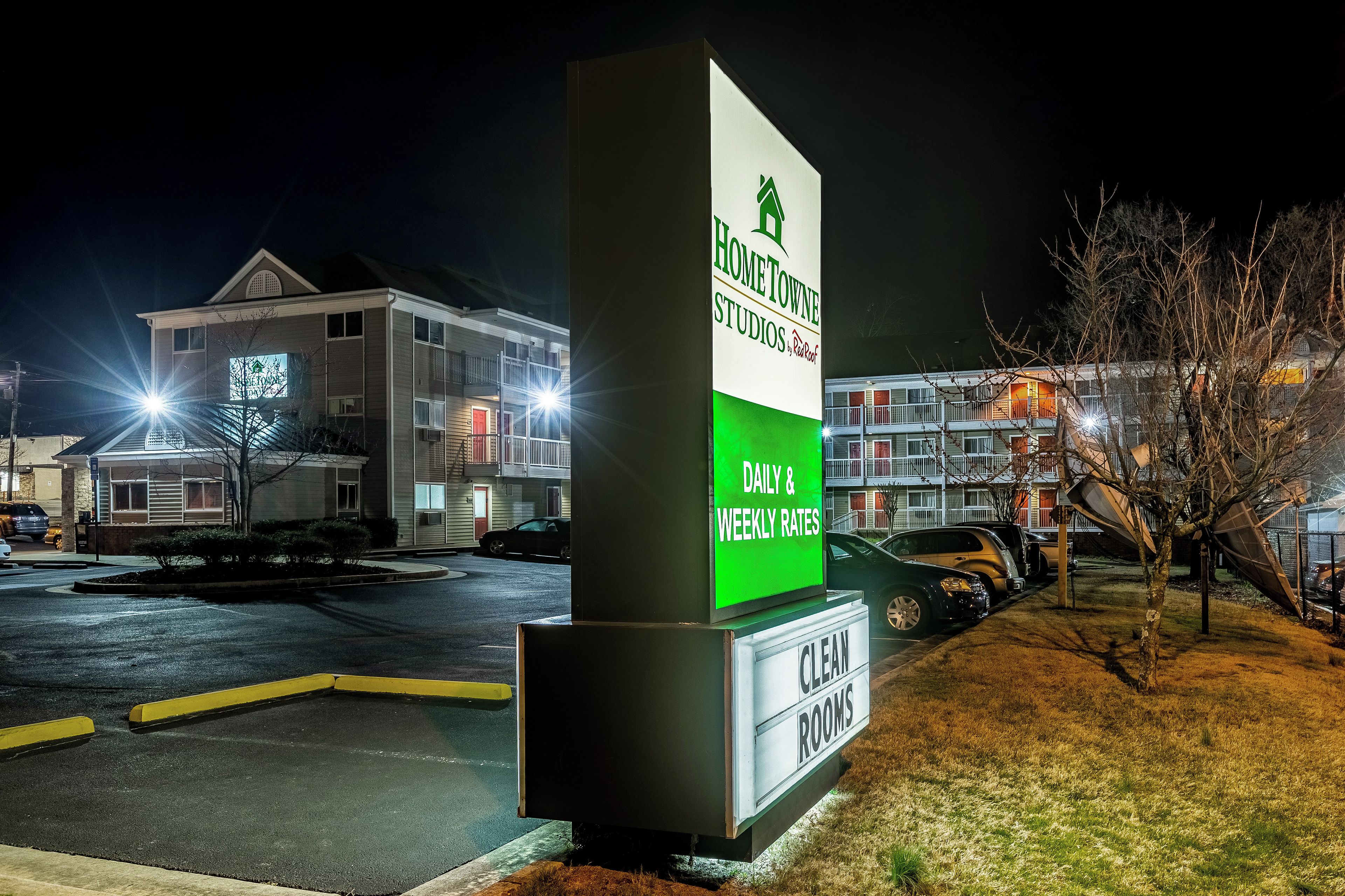 A sign for Hometown Studios with daily and weekly rates, indicating clean rooms.