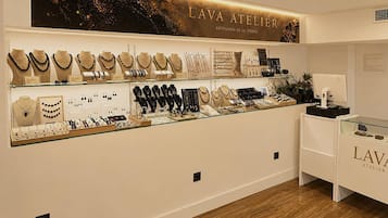 A jewelry store with various necklaces and earrings displayed on shelves.