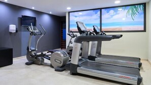 A gym with treadmills, an elliptical, and a stationary bike. - Catalonia Barcelona Beach (Barcelona)
