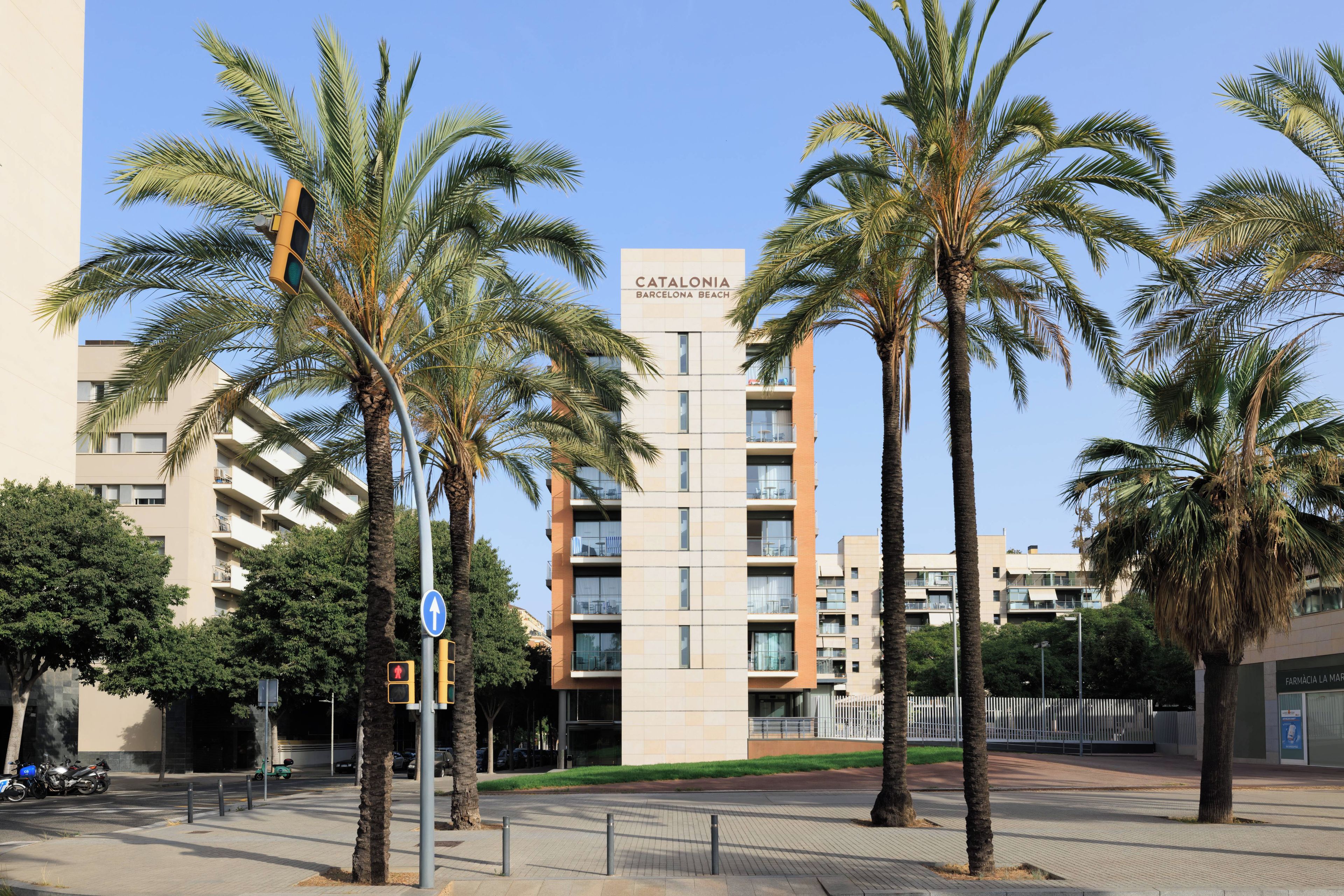 A modern building with a sign reading 'CATALONIA BARCELONA BEACH'.