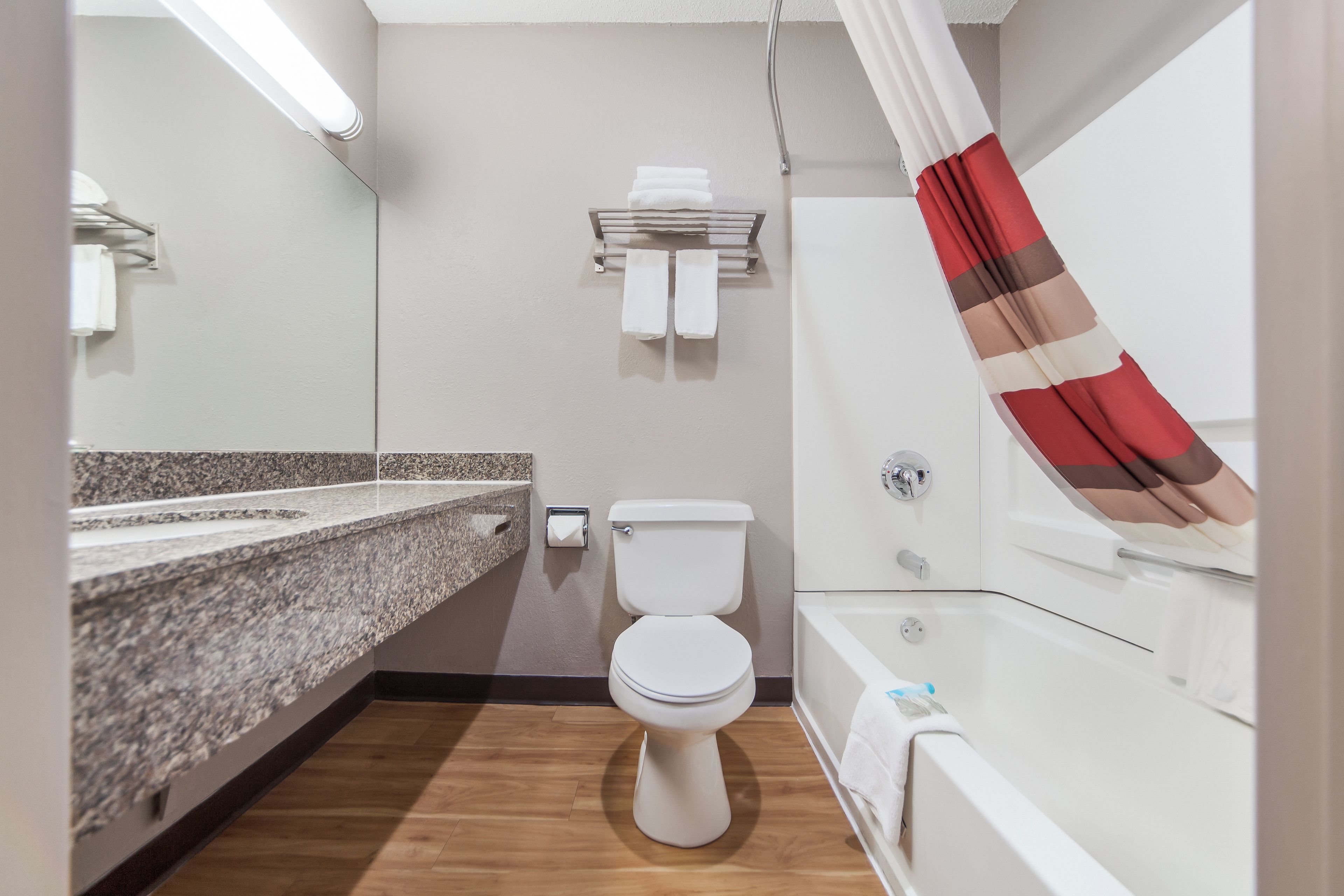 A bathroom with a toilet, sink, and bathtub.