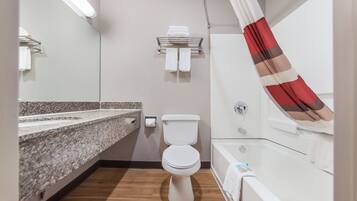 A bathroom with a toilet, sink, and bathtub.