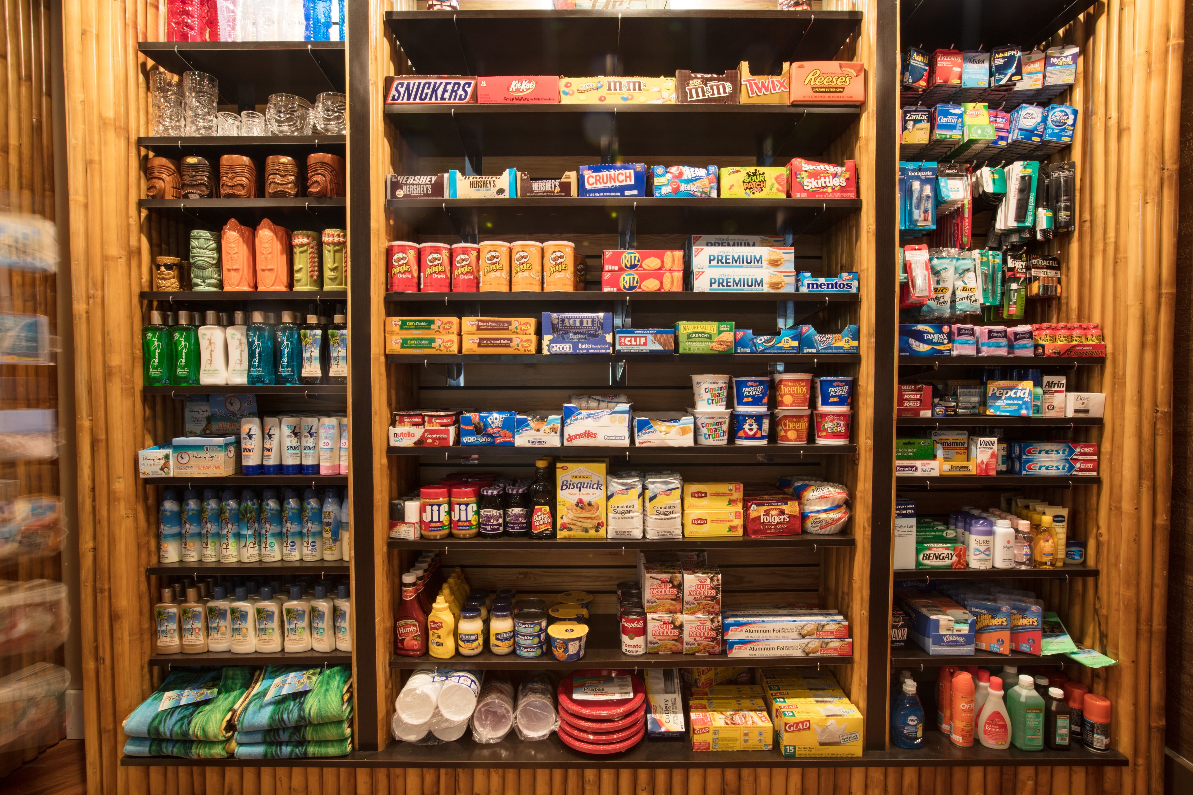 A store with shelves stocked with various food items, including snacks, cereals, and beverages.